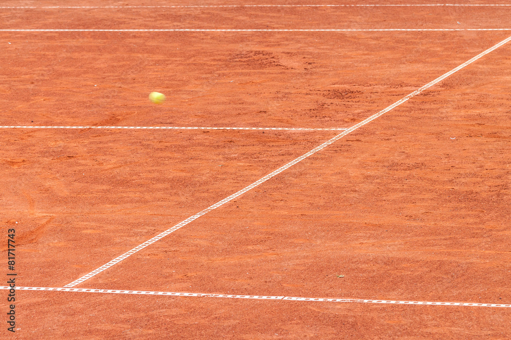 Tennis ball on a clay court