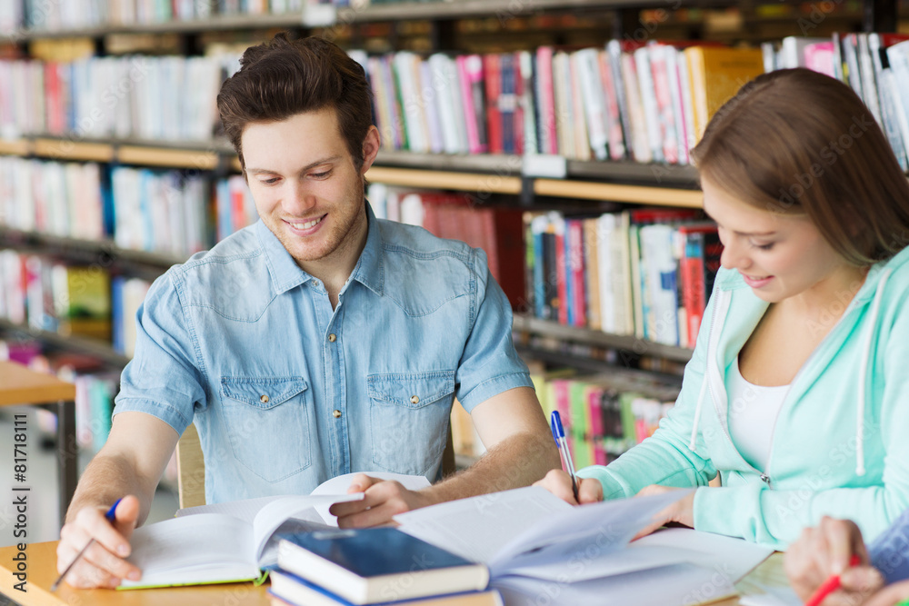 students with books preparing to exam in library students with books preparing to exam in library