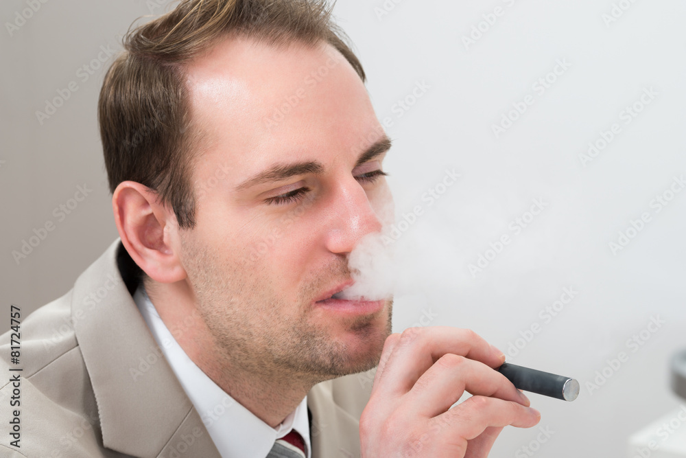 Businessman Smoking Electronic Cigarette Businessman Smoking Electronic Cigarette