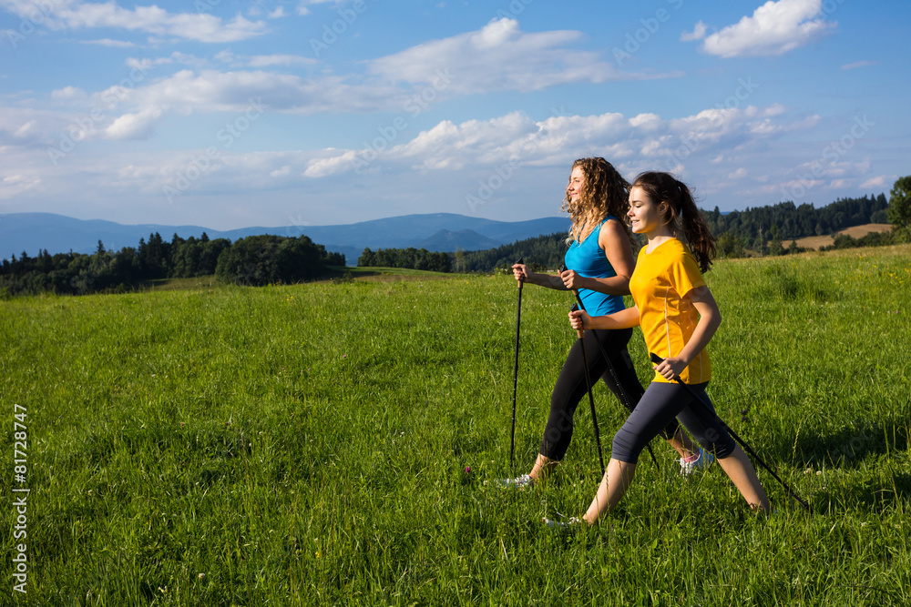 Nordic walking - active people working out outdoor Nordic walking - active people working out outdoor