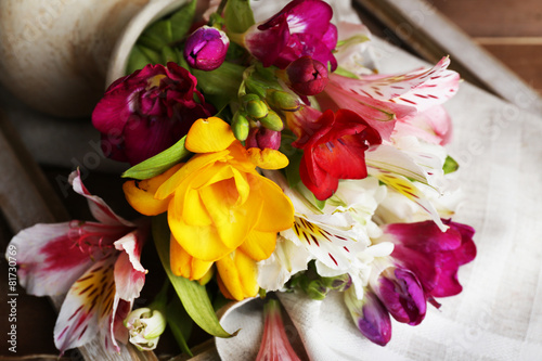 Beautiful spring flowers on wooden background