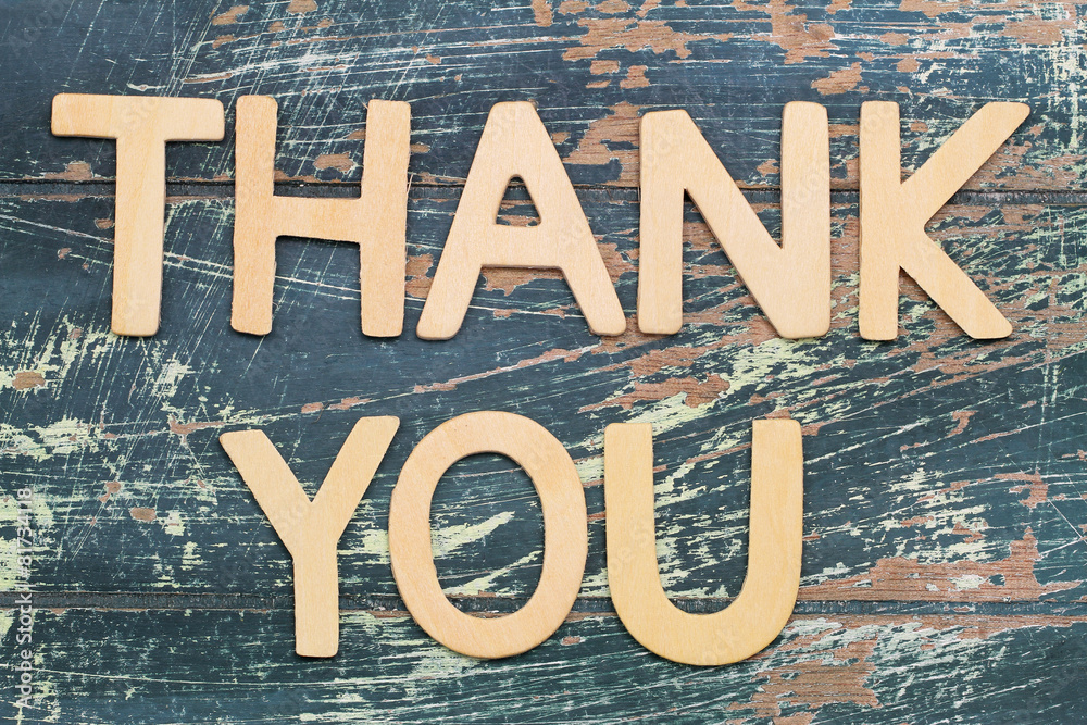 Thank you written with wooden letters on rustic wooden surface