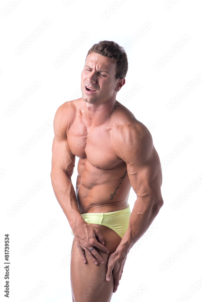 Fototapeta premium Muscular handsome man holding his thigh and leg in pain