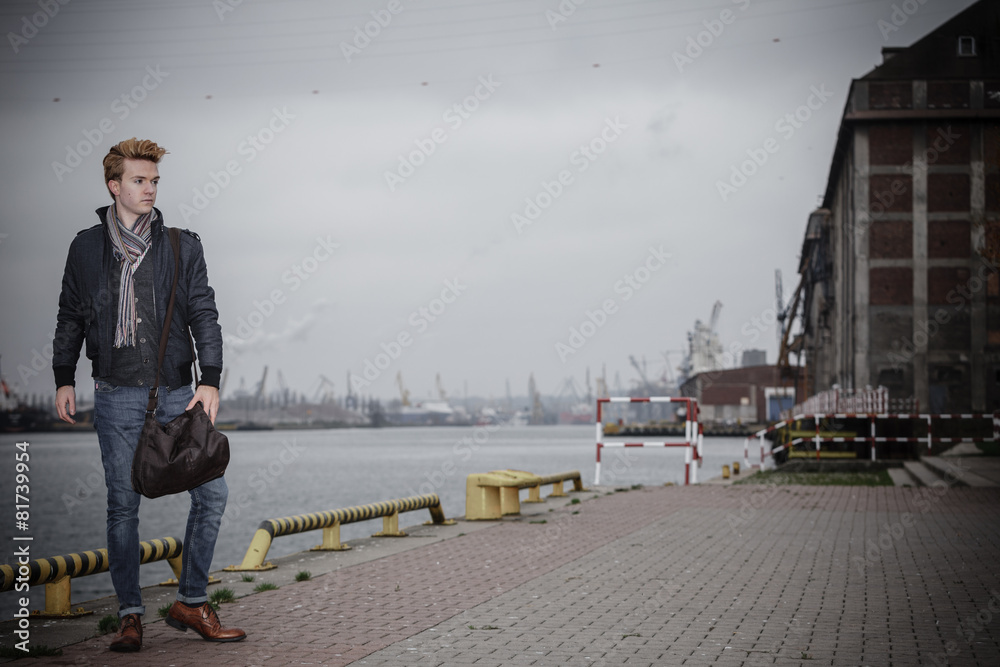 fashion model guy with bag outdoors