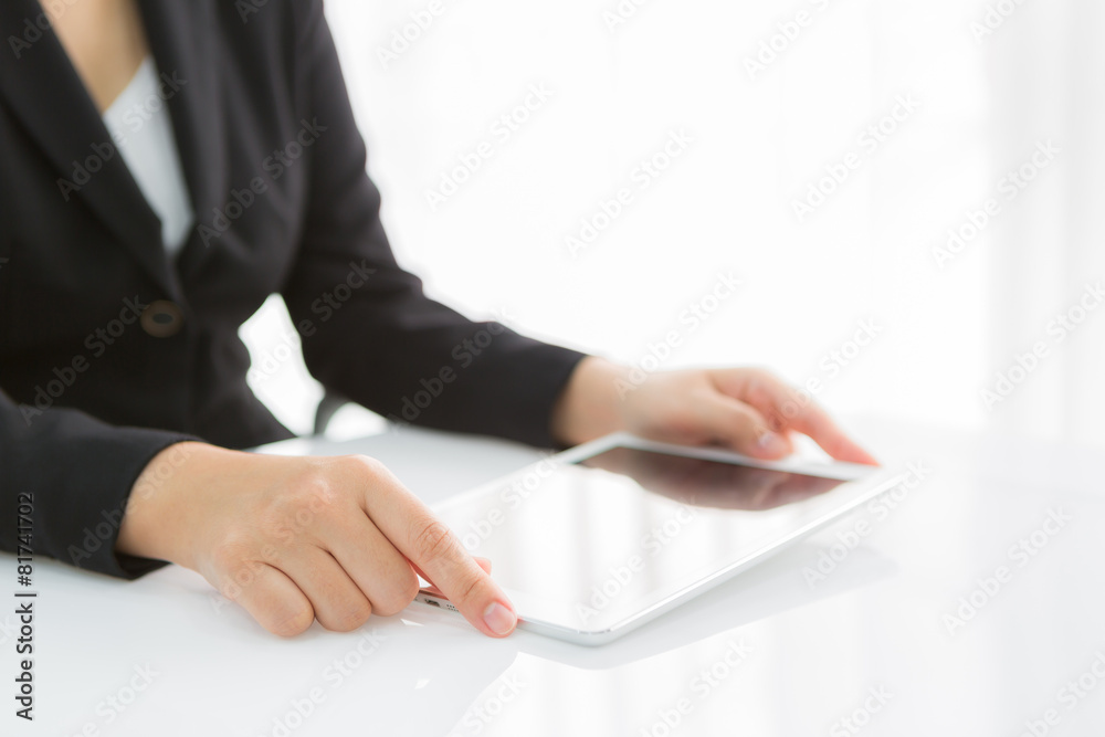Woman hand touch white tablet with blank empty screen Woman hand touch white tablet with blank empty screen