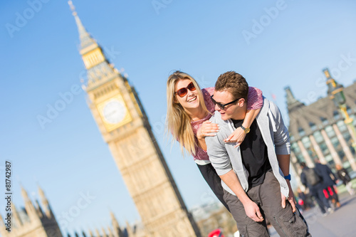 Photography Happy young couple enjoying a piggyback ride in London