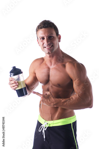 Muscular shirtless male bodybuilder holding protein shake bottle