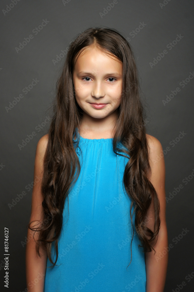 Beautiful child poses for the camera in studio.Isolated portrait Beautiful child poses for the camera in studio.Isolated portrait