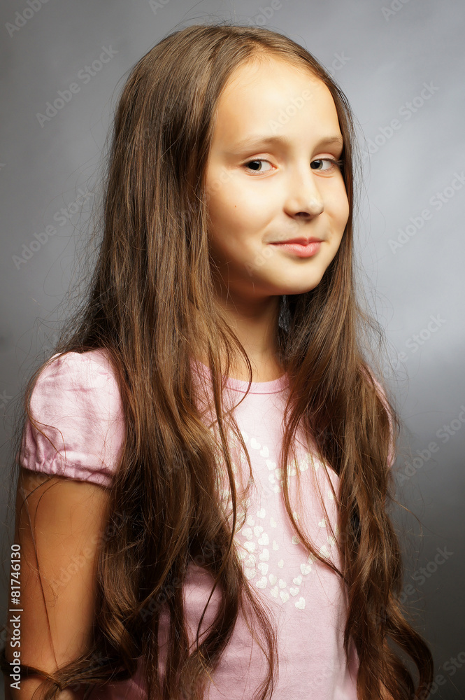 Beautiful child poses for the camera in studio.Isolated portrait Beautiful child poses for the camera in studio.Isolated portrait