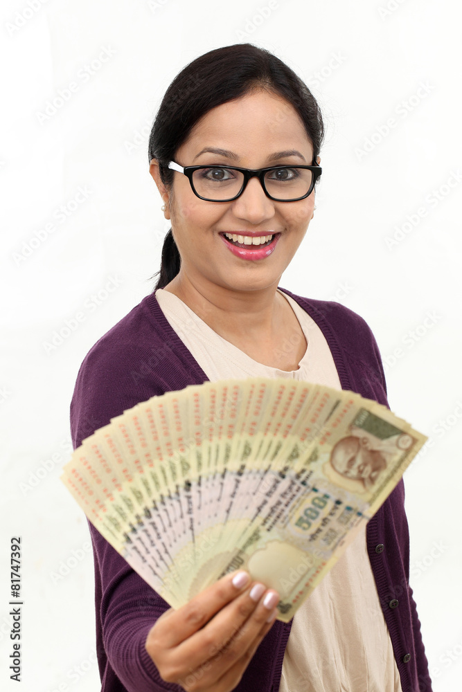 Excited successful young woman holding Indian rupee bills Excited successful young woman holding Indian rupee bills
