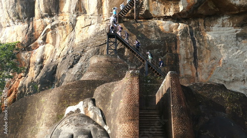 Tourists climb the stairs on Sigiriya Lion Rock Fortress in Sri 