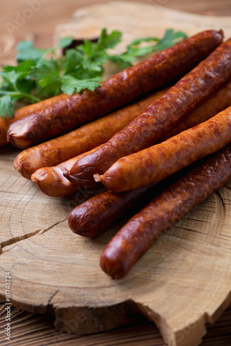 Smoked sausages with parsley, close-up, selective focus