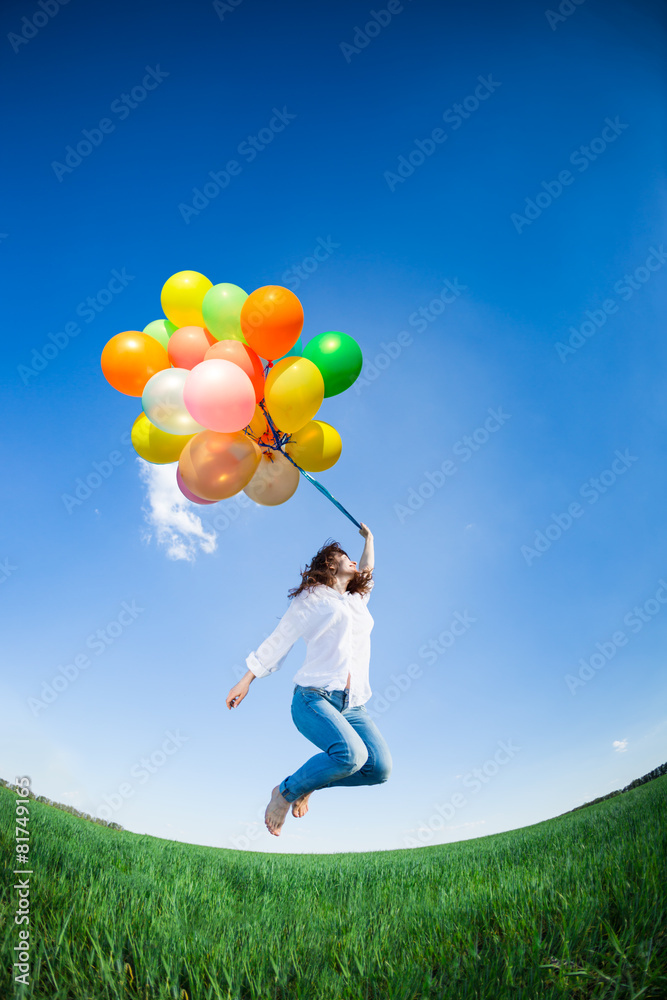 Woman with toy balloons in spring field