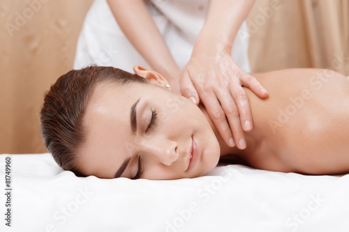 Masseur gives neck and shoulder massage