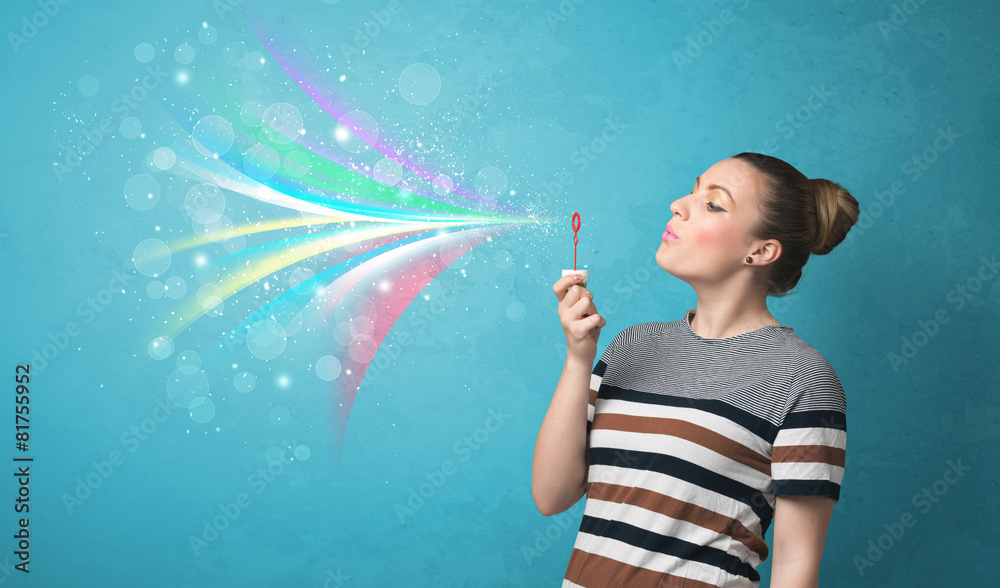 Beautiful girl blowing abstract colorful bubbles and lines