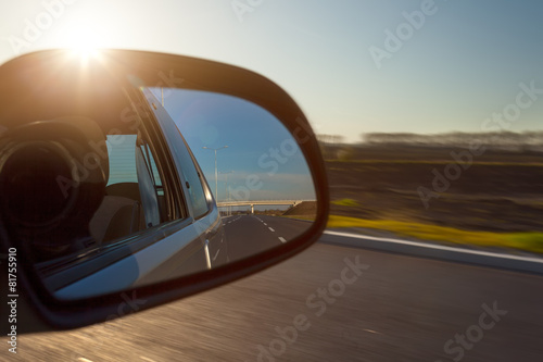 Rearview mirror and the setting sun from car