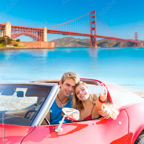 Photography selfie of young couple convertible car Golden Gate