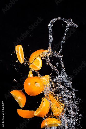 Oranges with water splashes on black background