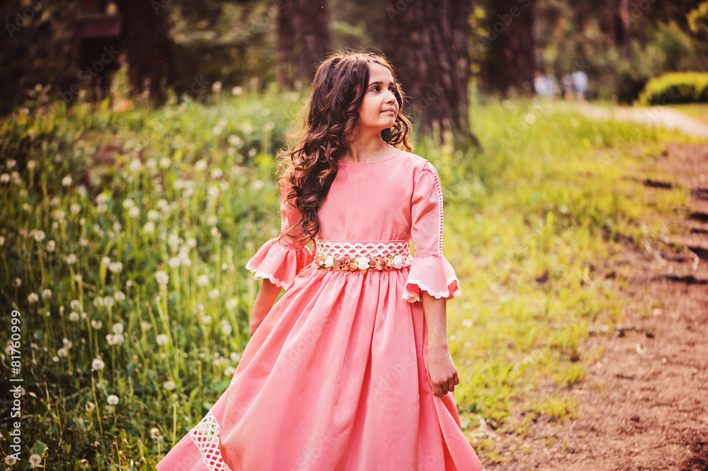 happy child girl in fairytale princess dress dancing in forest