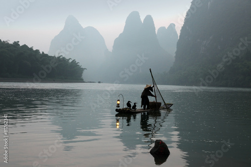 Chinese man fishing with cormorants birds in Yangshuo  Guangxi r