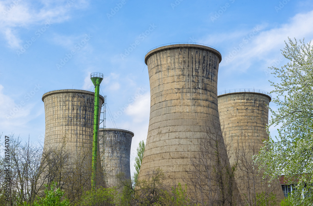 Power plant towers in spring green landscape and blue sky Power plant towers in spring green landscape and blue sky