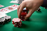 dealer collects red poker chips
