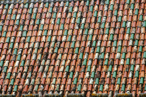roof tiles of different colors in the old building of Coimbra Po