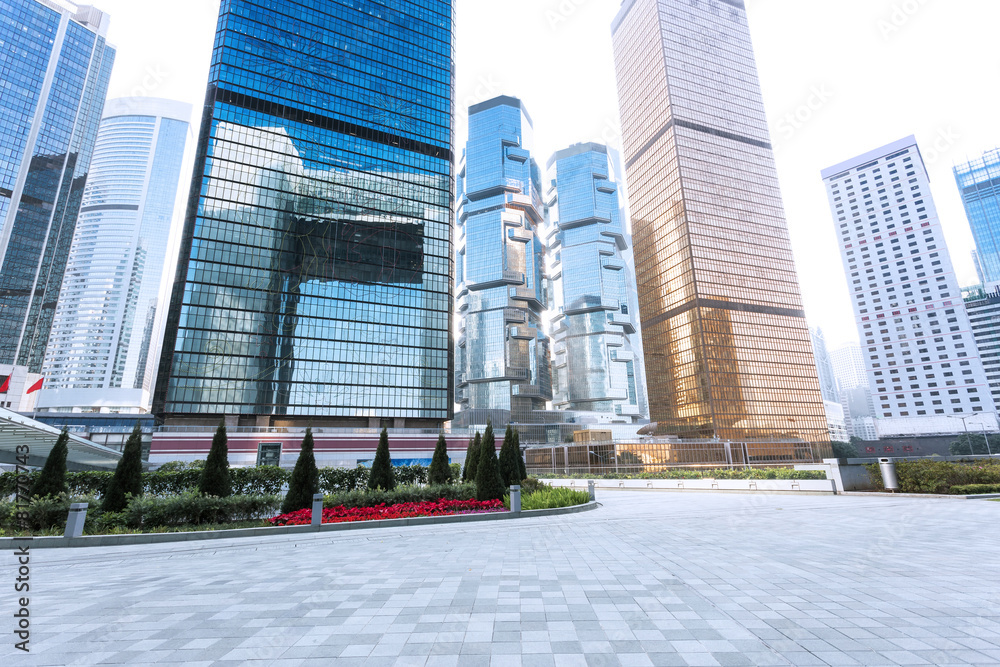 Naklejka premium empty pavement and skyscrapers in modern city