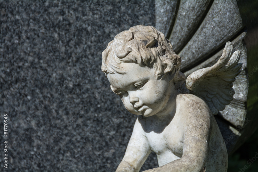 putto or child angel statue as a grave stone on a cemetery putto or child angel statue as a grave stone on a cemetery