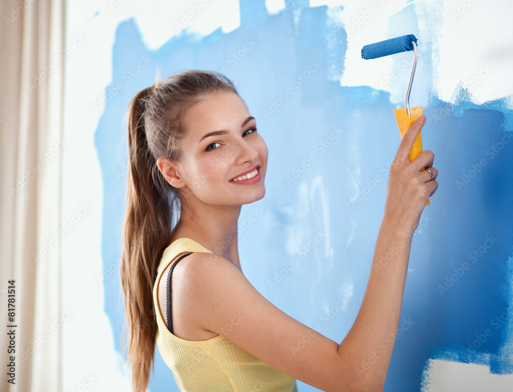 Happy beautiful young woman doing wall painting, Happy beautiful young woman doing wall painting,