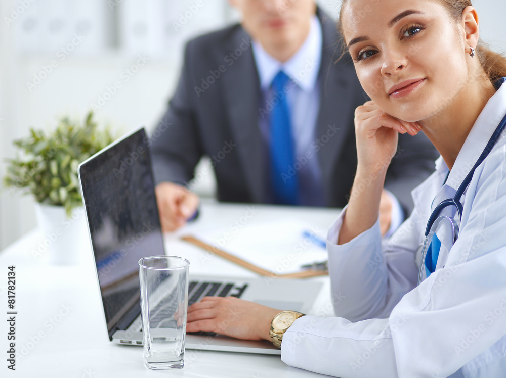 Medical team sitting at the table in modern hospital Medical team sitting at the table in modern hospital