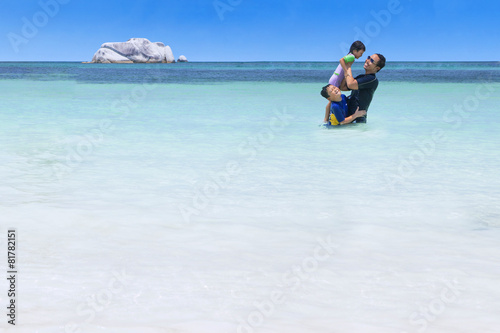 Playful family on the beach © Creativa Images