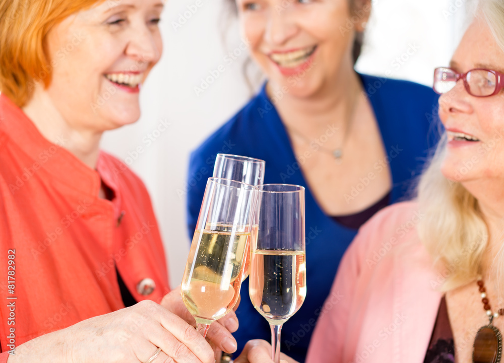 Glasses of White Wine Tossed by Happy Adult Ladies. Close up. Glasses of White Wine Tossed by Happy Adult Ladies. Close up.