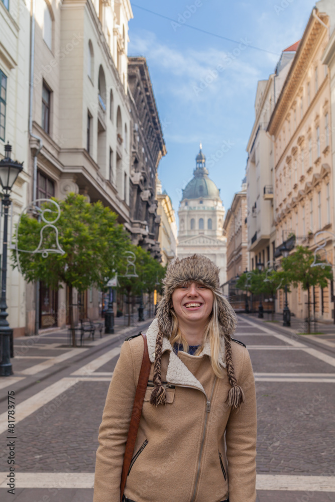 Portrait of a smiling girl in a cap on the Zrinyi street