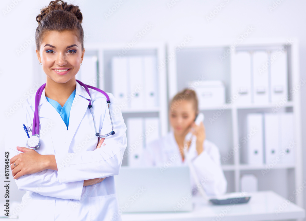 Portrait of young woman doctor with white coat standing in Portrait of young woman doctor with white coat standing in