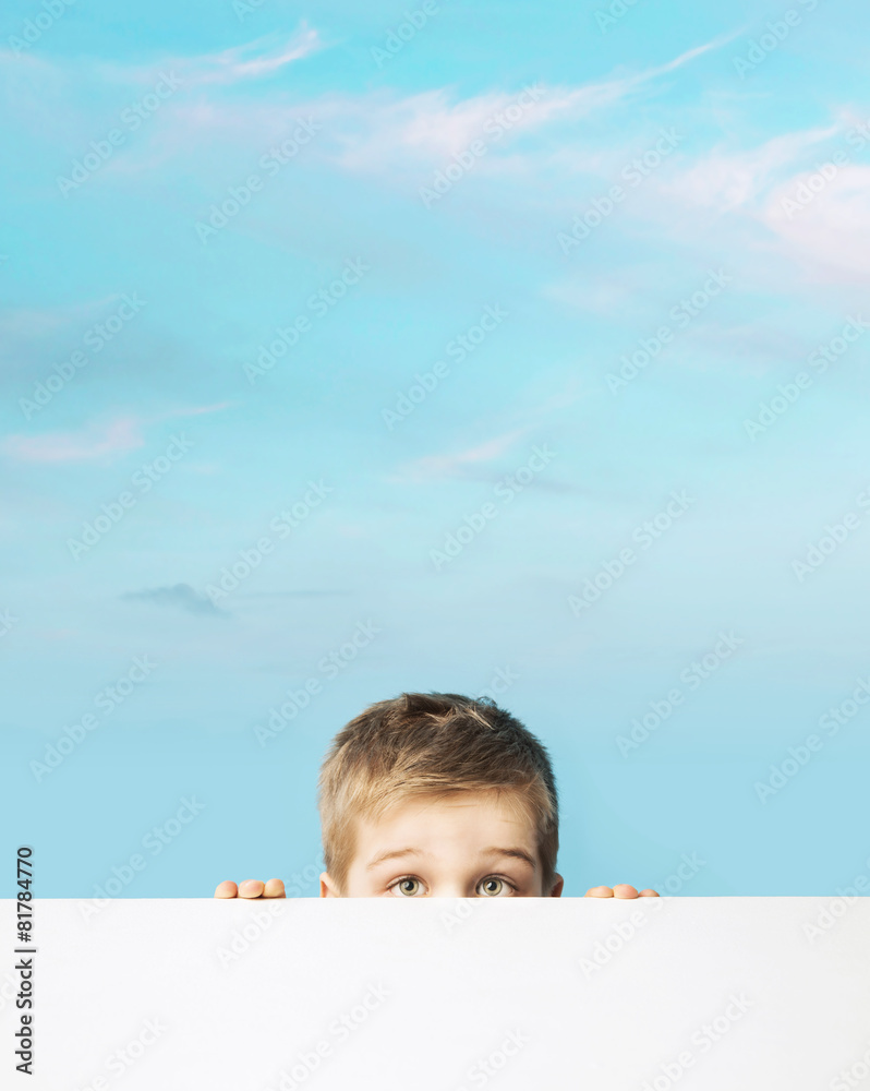 Fine portrait of a small boy hiding behind a board Fine portrait of a small boy hiding behind a board
