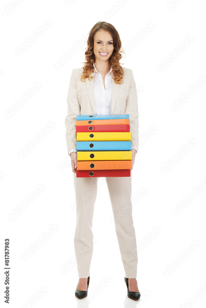 Female carrying heavy binders against. Female carrying heavy binders against.