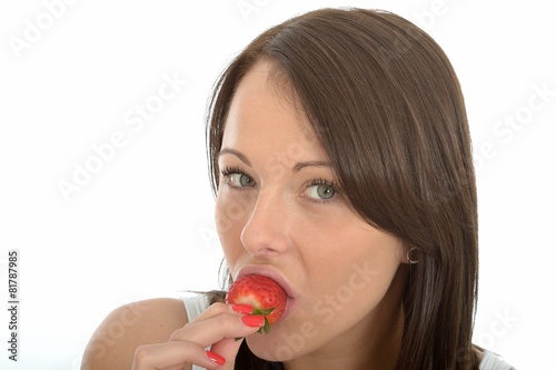 Attractive Healthy Young Woman Eating a Strawberry