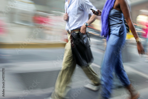 motion blurred business people walking on the street