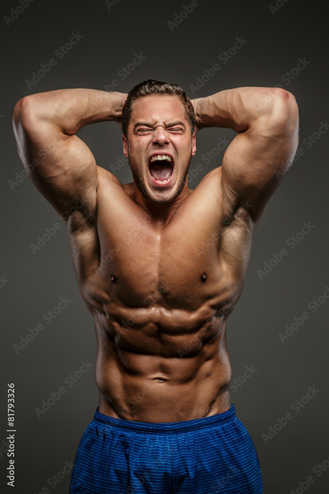 Fototapeta premium Awesome muscular guy on grey background