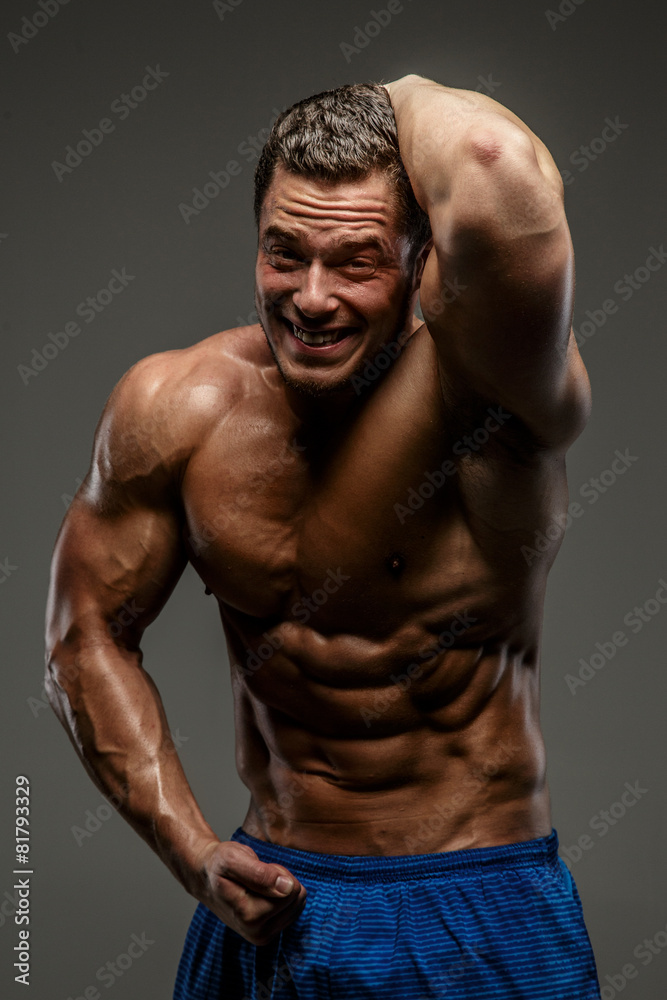 Awesome muscular guy on grey background