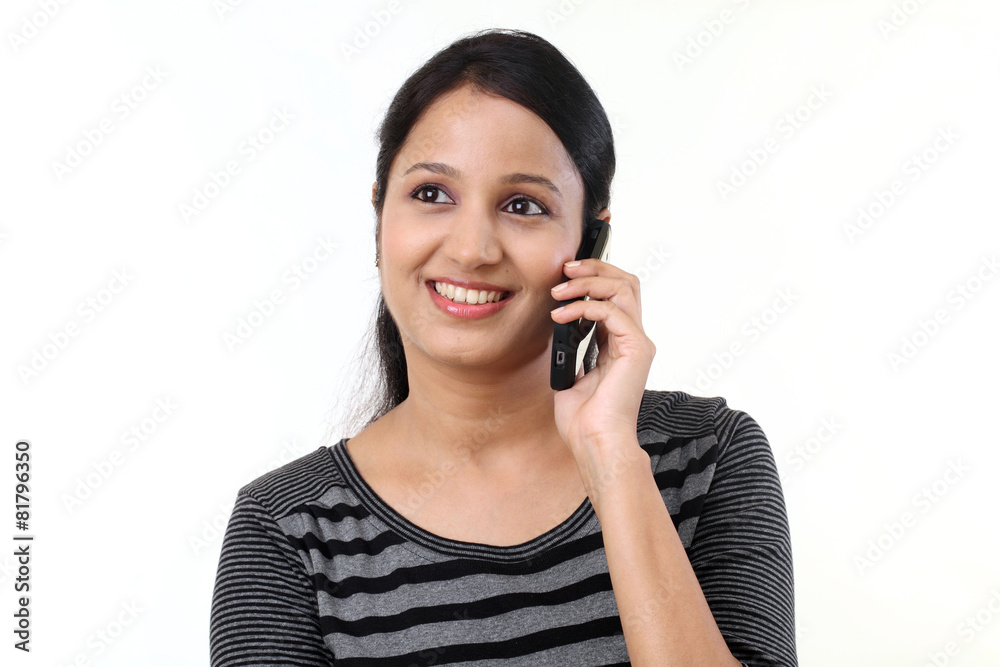 Happy young woman talking on mobile phone Happy young woman talking on mobile phone