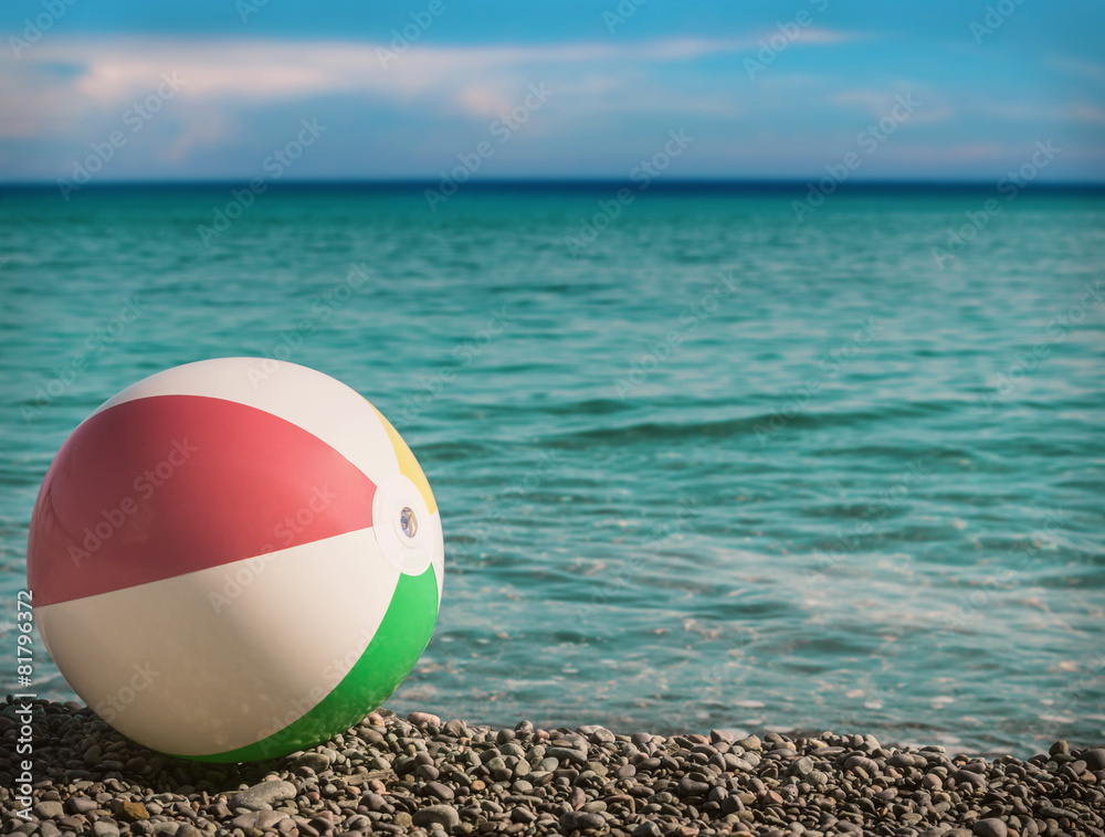 toy inflatable ball on the beach against the sea toy inflatable ball on the beach against the sea