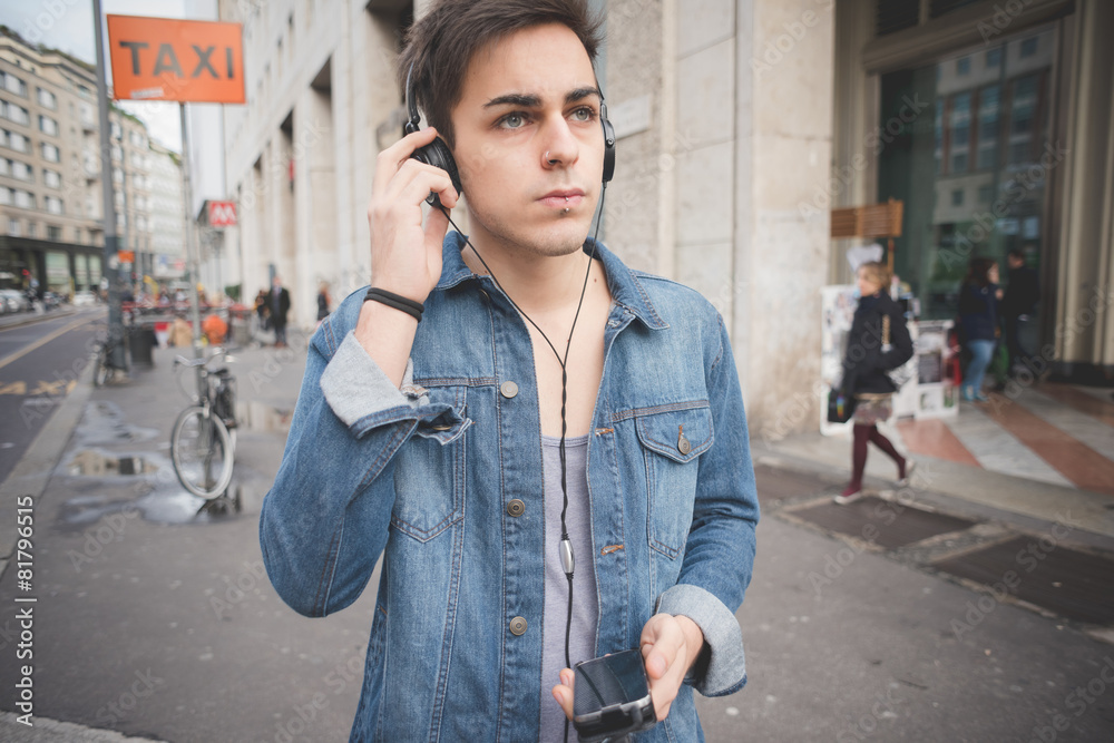 young handsome alternative dark model man in town listening to m young handsome alternative dark model man in town listening to m