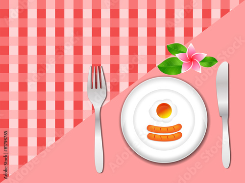 fried egg in plate with fork and knife on tablecloth, breakfast
