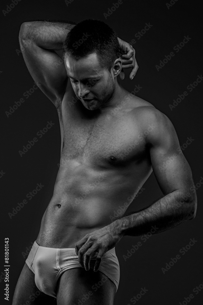 Fototapeta premium Man in panties posing on gray background