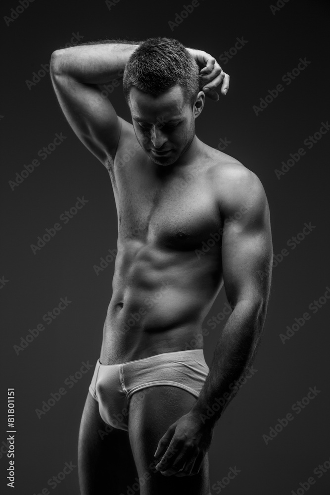 Fototapeta premium Man in panties posing on gray background