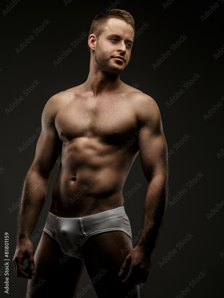 Fototapeta premium Man in white panties posing in studio