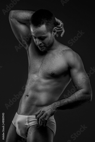 Man in panties posing on gray background
