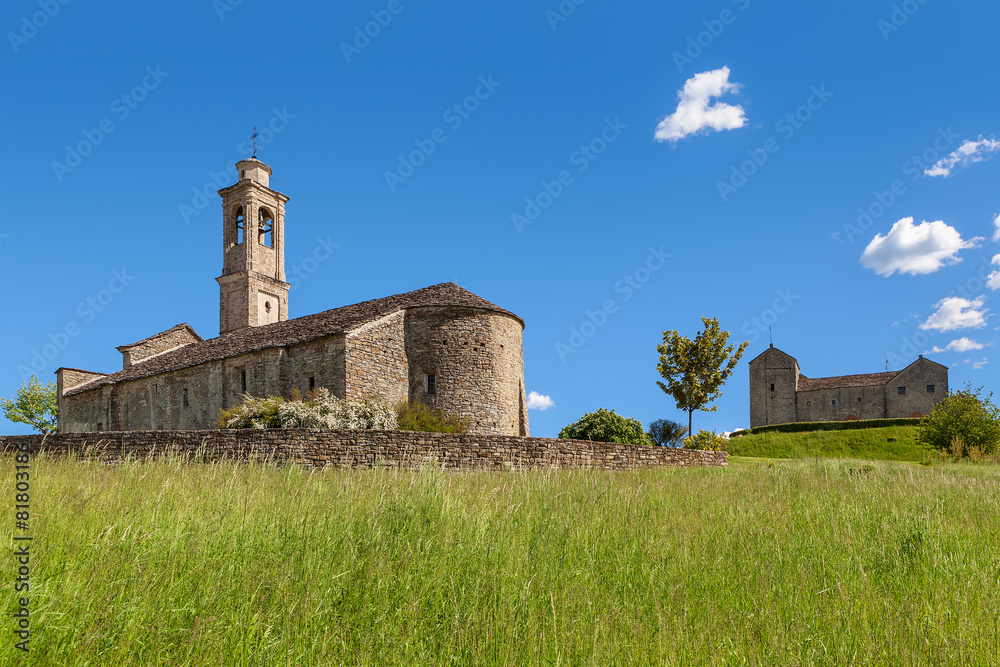 Old church under blue sky in Piedmont, Italy.